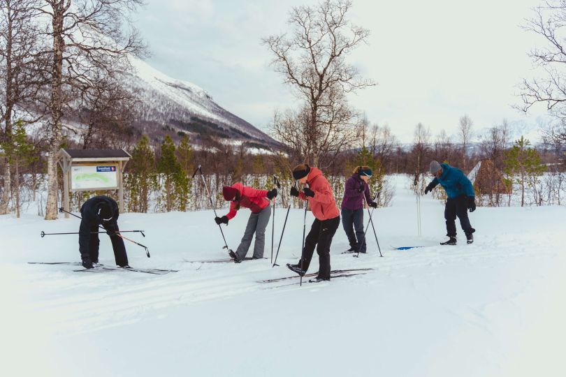 Group of people are getting ready to cross-country skii.