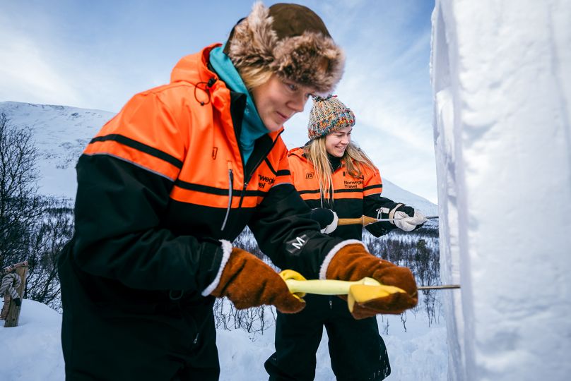 Woman carving sculpture in snow