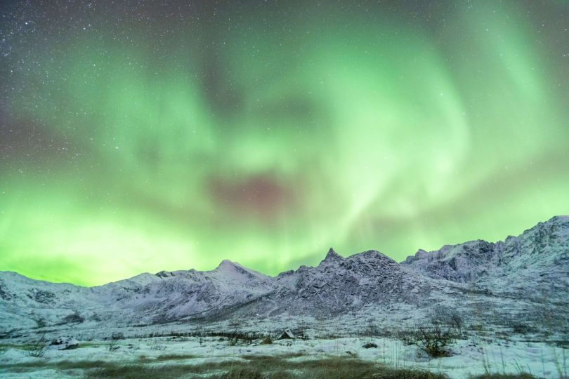 Northern lights in diffrent colors over mountain