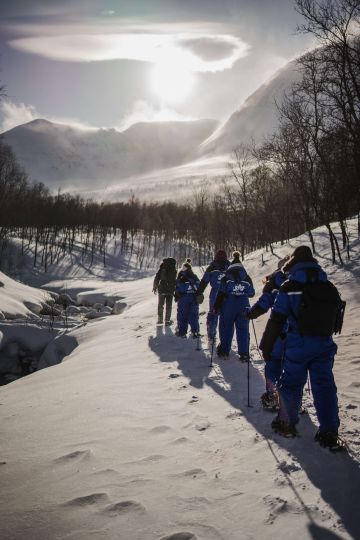 Group of people doing their snowshoeing tour