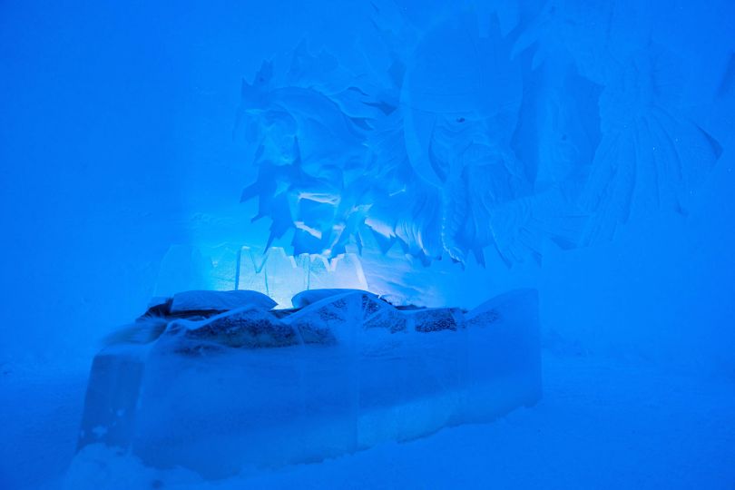 Bed covered with reindeer skin in side of Ice Dom