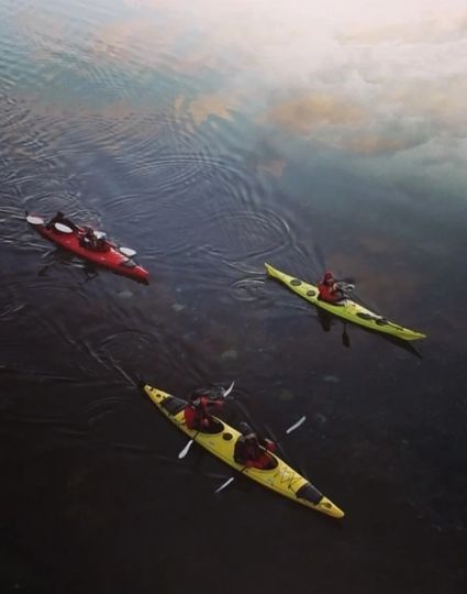 Four people kayaking in Tromso Norway during winter