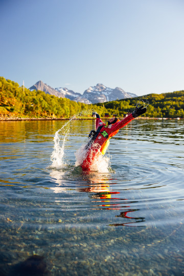 midnight fjord floating safari, person jumping into the sea