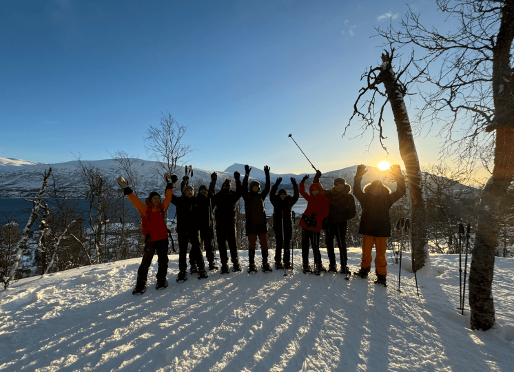 group of the poeple standing on top of the hill