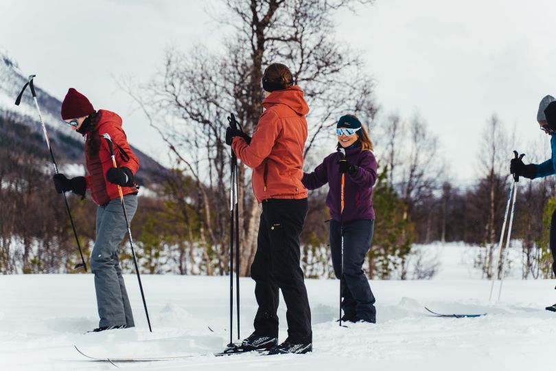 Group of people are getting ready to cross-country skii.