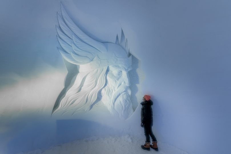 Woman standing next to Ice sculpture