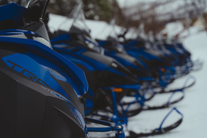 Snowmobiles parked in snow