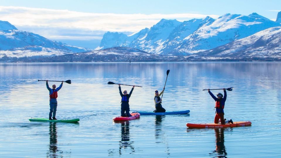 Four people stand-up paddleboarding in May